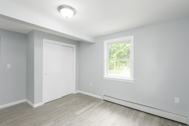 37 Martin St, Hartford, CT 06120 - unfurnished bedroom with a baseboard radiator, light wood-type flooring, and a closet