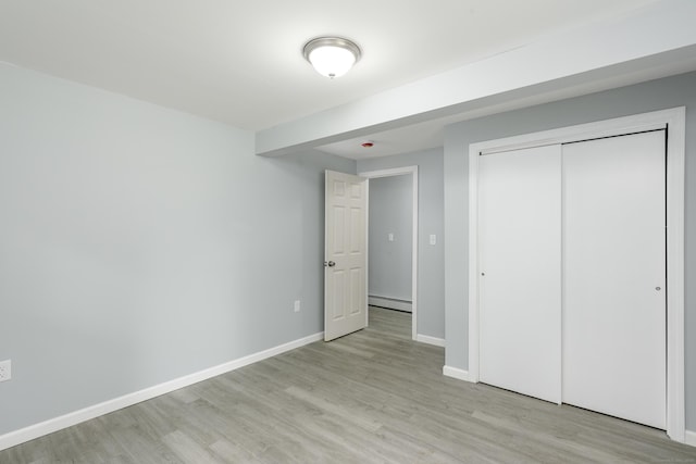 37 Martin St, Hartford, CT 06120 - unfurnished bedroom featuring a baseboard heating unit, light wood finished floors, and a closet