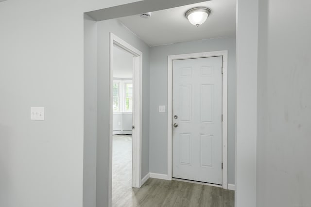 37 Martin St, Hartford, CT 06120 - doorway with light wood-style floors and a baseboard radiator