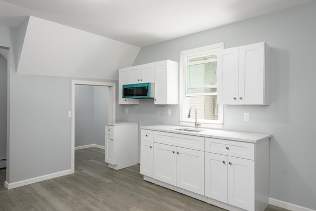 37 Martin St, Hartford, CT 06120 - kitchen featuring white cabinetry, light wood-type flooring, and lofted ceiling