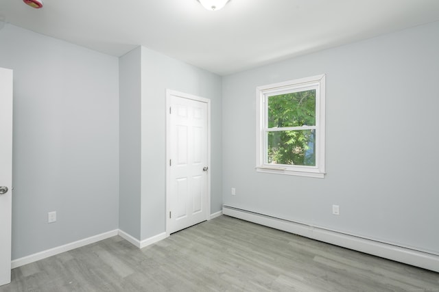 37 Martin St, Hartford, CT 06120 - unfurnished bedroom featuring baseboard heating and wood finished floors