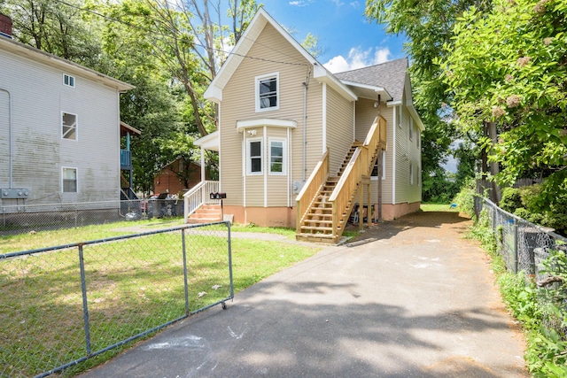 37 Martin St, Hartford, CT 06120 - view of front facade with asphalt driveway, roof with shingles, and stairway