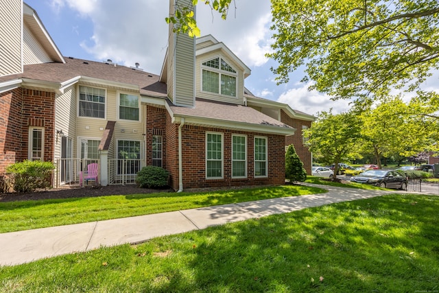 289 Carriage Crossing Ln Unit 289, Middletown, CT 06457 - view of front of property featuring a front lawn, brick siding, a chimney, and a shingled roof
