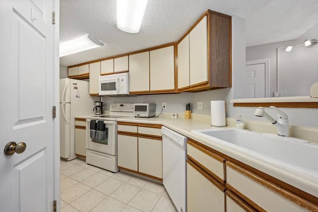 289 Carriage Crossing Ln Unit 289, Middletown, CT 06457 - kitchen with white appliances, a textured ceiling, light countertops, and light tile patterned floors