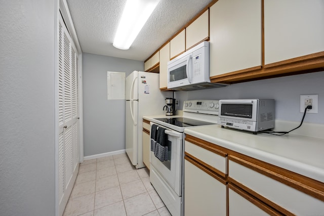 289 Carriage Crossing Ln Unit 289, Middletown, CT 06457 - kitchen featuring white appliances, light countertops, a textured ceiling, light tile patterned flooring, and white cabinetry
