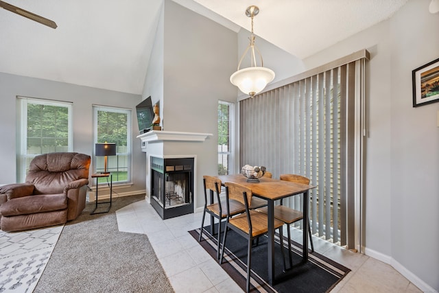 289 Carriage Crossing Ln Unit 289, Middletown, CT 06457 - dining area with healthy amount of natural light, a multi sided fireplace, tile patterned floors, and high vaulted ceiling