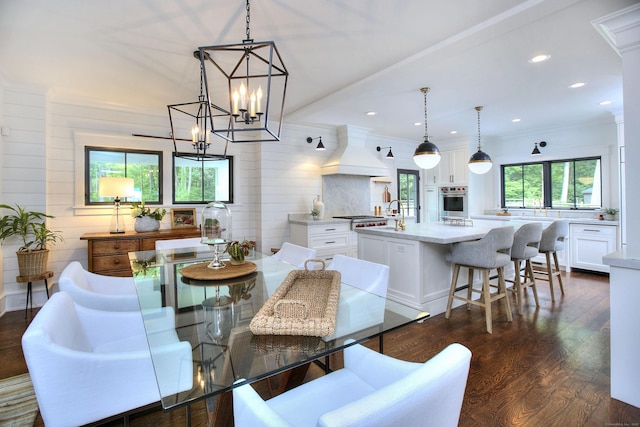 229 Good Hill Rd, Weston, CT 06883 - dining area featuring dark wood-type flooring, wooden walls, a chandelier, recessed lighting, and ornamental molding