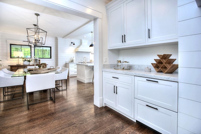 229 Good Hill Rd, Weston, CT 06883 - kitchen with dark wood-style floors, a chandelier, white cabinets, hanging light fixtures, and light stone counters