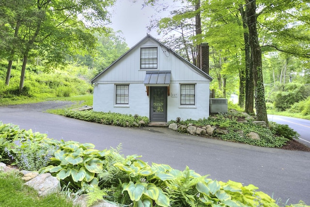 229 Good Hill Rd, Weston, CT 06883 - view of front of property featuring a standing seam roof, a metal roof, a chimney, and stucco siding