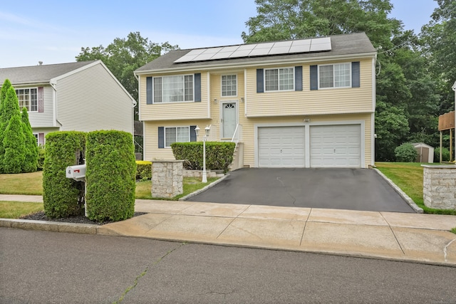 4 Russo Ter, New Haven, CT 06513 - raised ranch featuring asphalt driveway, solar panels, a garage, and a storage shed