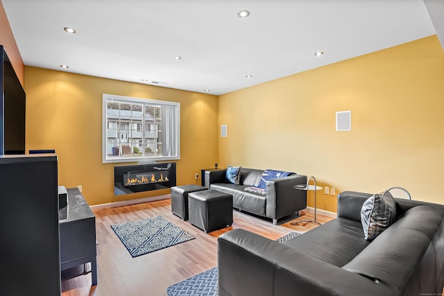 4 Russo Ter, New Haven, CT 06513 - living area with a glass covered fireplace, light wood-type flooring, and recessed lighting
