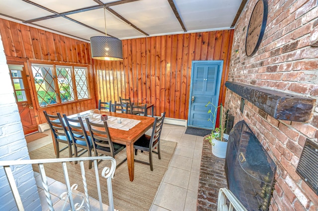 93 Glenrock Rd, Waterbury, CT 06706 - dining space with wood walls, light tile patterned floors, a baseboard radiator, and a fireplace