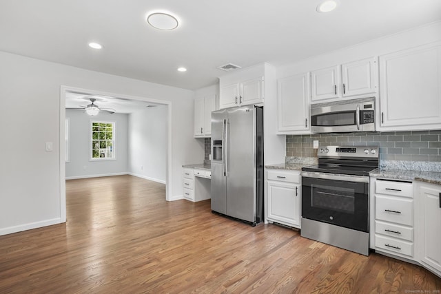 75 Beecher Ave, Shelton, CT 06484 - kitchen with appliances with stainless steel finishes, light wood-style flooring, backsplash, white cabinets, and recessed lighting