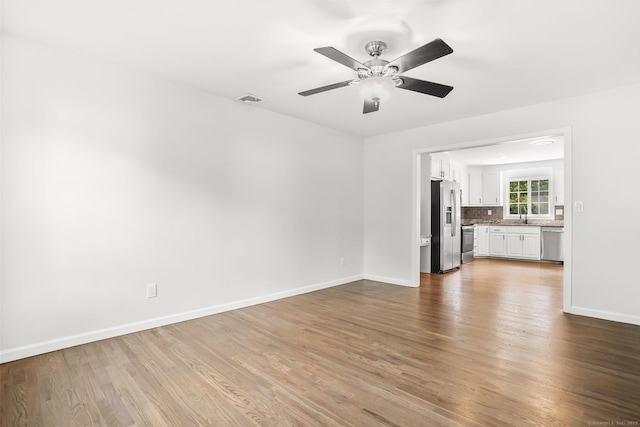 75 Beecher Ave, Shelton, CT 06484 - unfurnished living room with wood finished floors and a ceiling fan