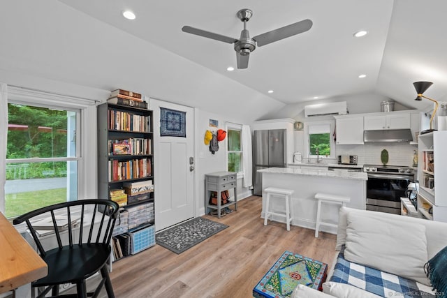 20 Meadow Woods Rd, Essex, CT 06426 - living area with vaulted ceiling, light wood-type flooring, ceiling fan, a wall mounted air conditioner, and recessed lighting