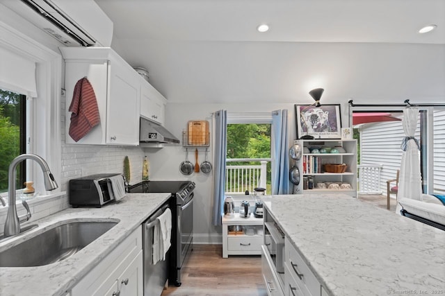 20 Meadow Woods Rd, Essex, CT 06426 - kitchen featuring under cabinet range hood, stainless steel appliances, white cabinetry, light wood finished floors, and tasteful backsplash