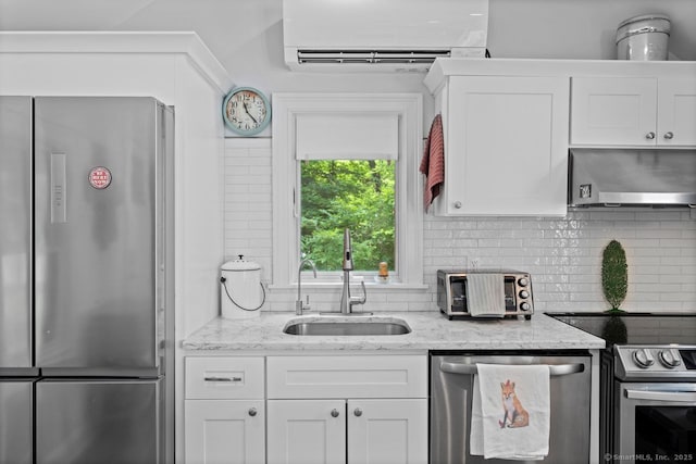 20 Meadow Woods Rd, Essex, CT 06426 - kitchen with appliances with stainless steel finishes, a wall mounted air conditioner, ventilation hood, backsplash, and white cabinets
