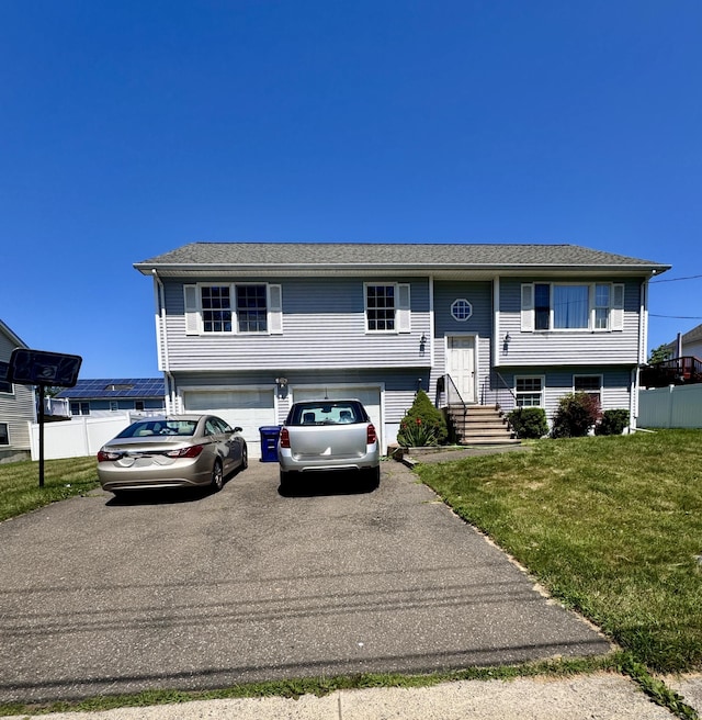 71 Harold St, West Haven, CT 06516 - bi-level home featuring asphalt driveway, an attached garage, and entry steps