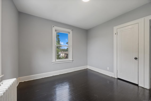120 Monmouth Ave, Waterbury, CT 06704 - unfurnished room featuring radiator and dark wood-style flooring
