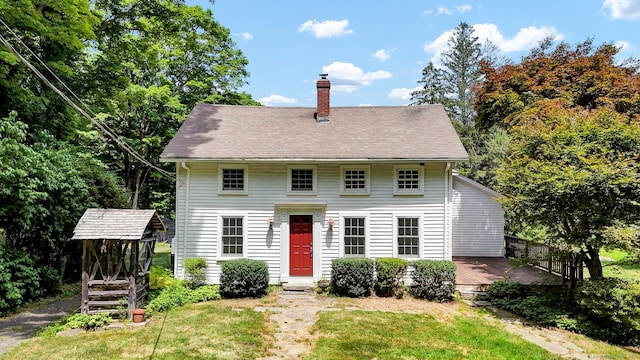 795 Rte 148, Killingworth, CT 06419 - colonial-style house featuring a chimney, a wooden deck, and a front yard