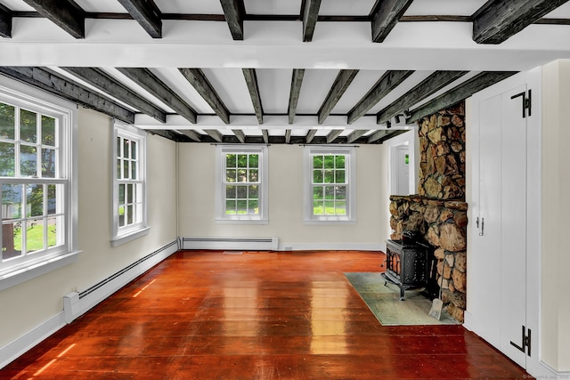 795 Rte 148, Killingworth, CT 06419 - unfurnished living room with wood-type flooring, beam ceiling, a wood stove, and a baseboard radiator