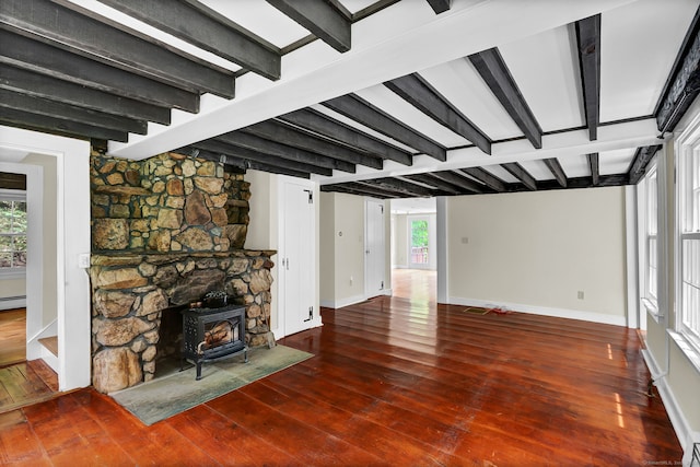 795 Rte 148, Killingworth, CT 06419 - living area featuring a wood stove, hardwood / wood-style flooring, beam ceiling, and a baseboard heating unit