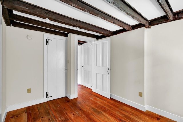 795 Rte 148, Killingworth, CT 06419 - unfurnished bedroom with beamed ceiling and dark wood-style flooring
