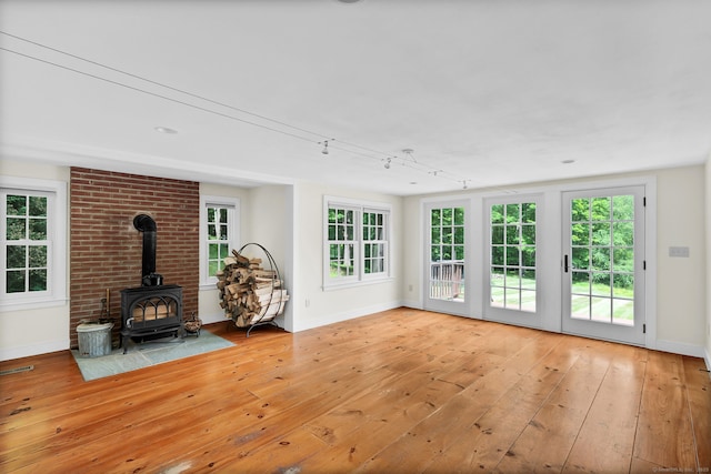 795 Rte 148, Killingworth, CT 06419 - unfurnished living room with light wood-style floors and a wood stove