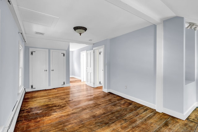 795 Rte 148, Killingworth, CT 06419 - unfurnished bedroom with a baseboard heating unit, wood-type flooring, and two closets
