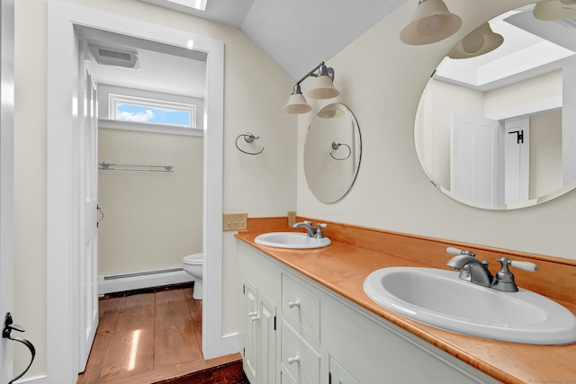 795 Rte 148, Killingworth, CT 06419 - bathroom with a baseboard heating unit, double vanity, hardwood / wood-style floors, and lofted ceiling