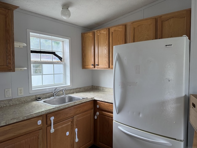 26 N Main St Trlr 19, Branford, CT 06405 - kitchen featuring freestanding refrigerator, brown cabinets, light countertops, a textured ceiling, and vaulted ceiling