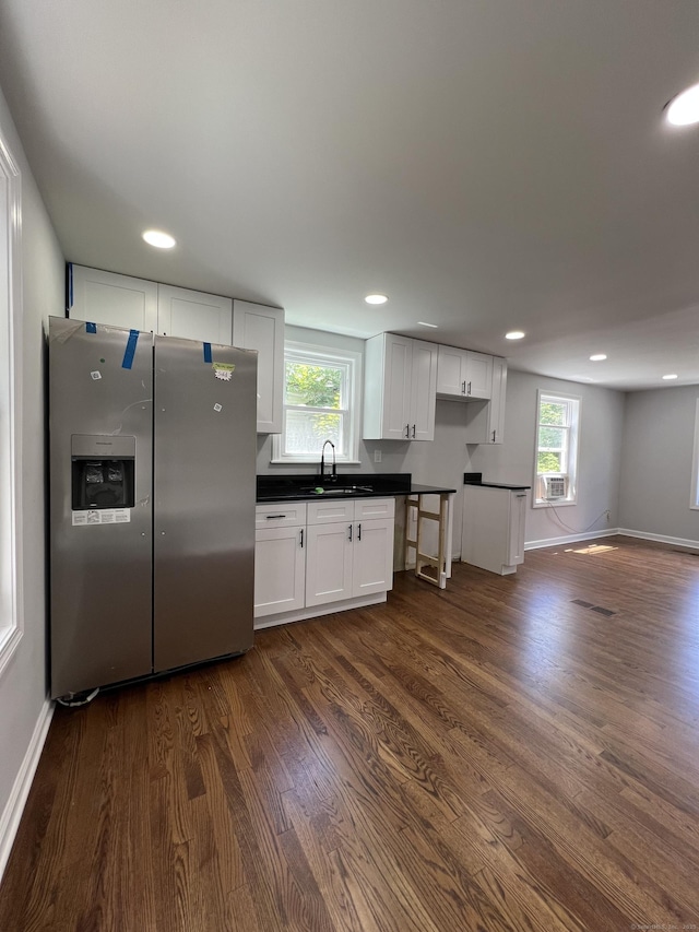 2308 N Main St, Waterbury, CT 06704 - kitchen featuring stainless steel fridge with ice dispenser, dark countertops, dark wood finished floors, and recessed lighting