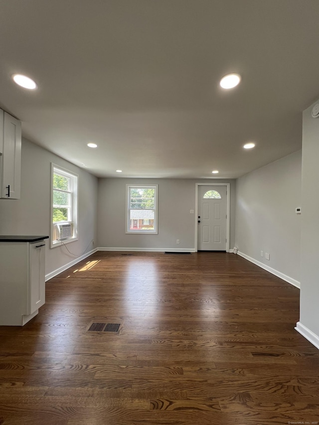 2308 N Main St, Waterbury, CT 06704 - unfurnished living room featuring plenty of natural light, dark wood-style flooring, recessed lighting, and cooling unit