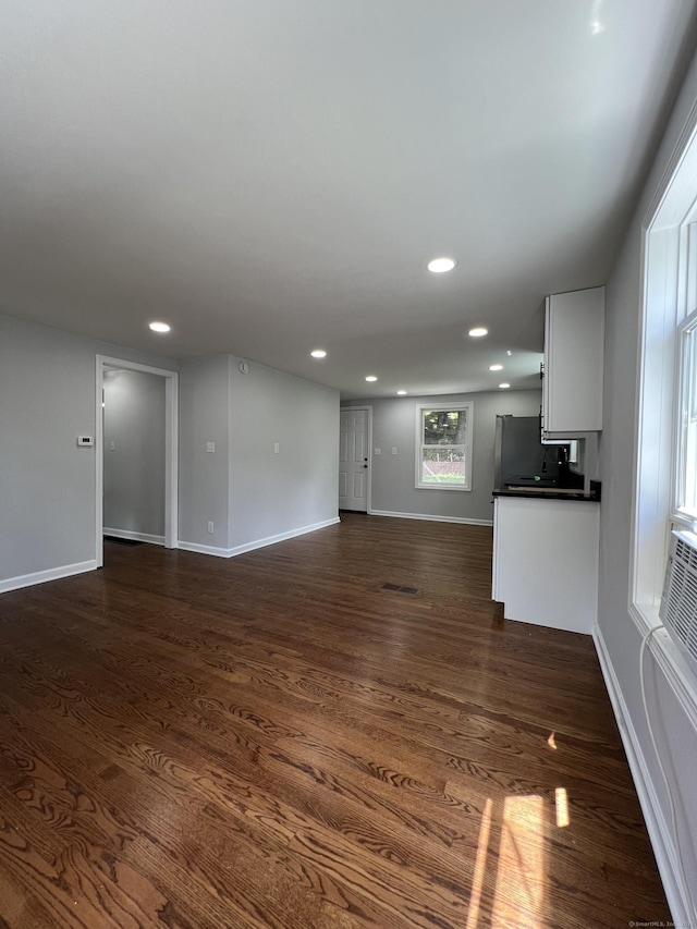 2308 N Main St, Waterbury, CT 06704 - unfurnished living room with dark wood-style floors and recessed lighting