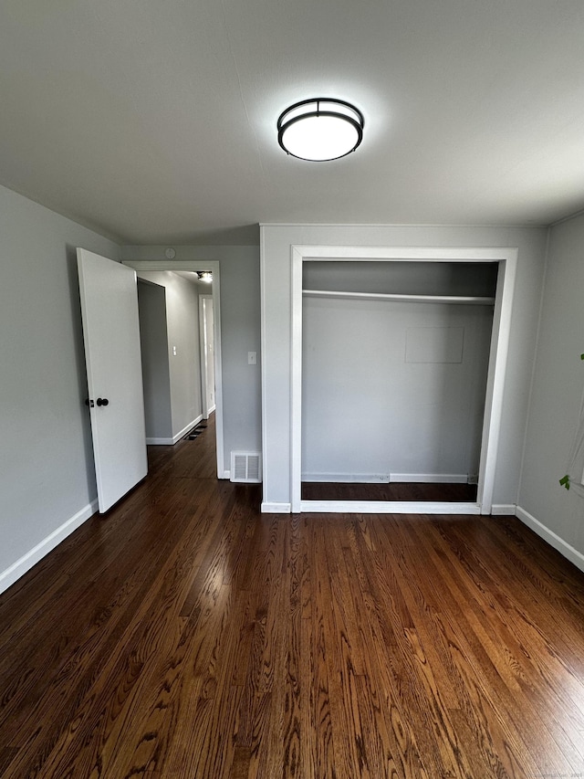 2308 N Main St, Waterbury, CT 06704 - unfurnished bedroom featuring dark wood finished floors and a closet