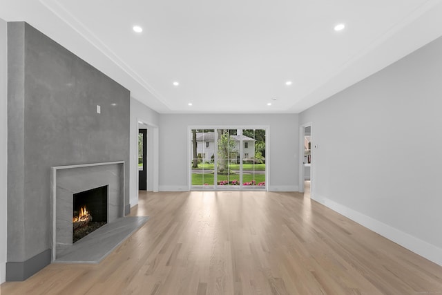 92 Westwood Rd, Fairfield, CT 06825 - unfurnished living room featuring healthy amount of natural light, a fireplace, light wood finished floors, and recessed lighting
