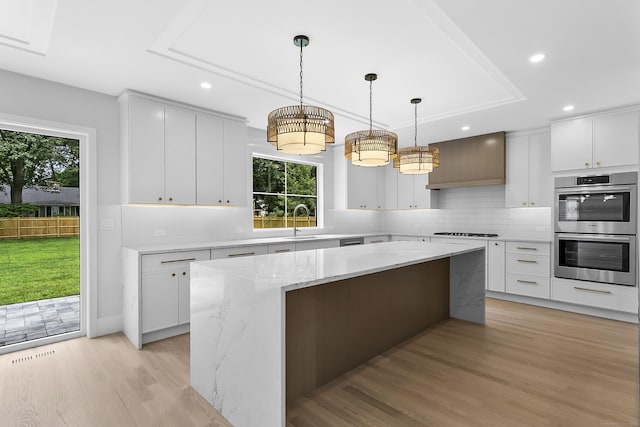 92 Westwood Rd, Fairfield, CT 06825 - kitchen with stainless steel double oven, gas stovetop, plenty of natural light, recessed lighting, and a raised ceiling