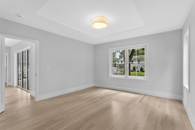 92 Westwood Rd, Fairfield, CT 06825 - empty room with light wood-style floors, a smoke detector, and a raised ceiling