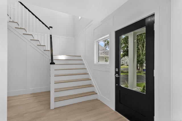 92 Westwood Rd, Fairfield, CT 06825 - foyer entrance with stairs, light wood finished floors, and a decorative wall
