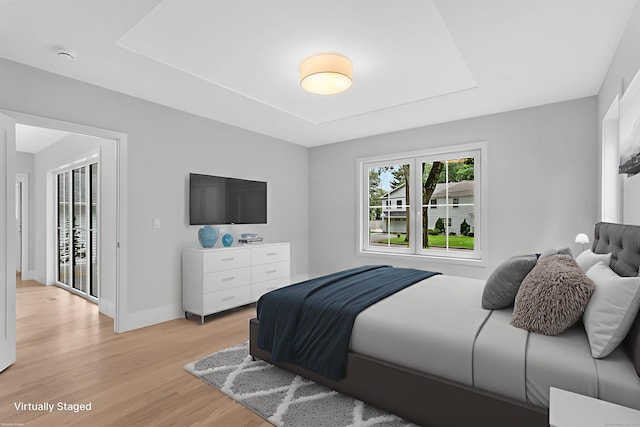 92 Westwood Rd, Fairfield, CT 06825 - bedroom with a raised ceiling and light wood-style flooring