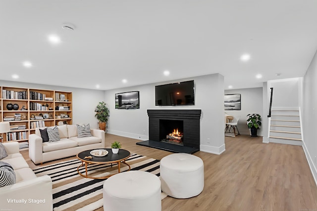 92 Westwood Rd, Fairfield, CT 06825 - living area featuring light wood finished floors, a fireplace, stairway, and recessed lighting