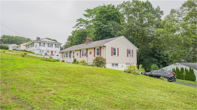 83 View Ter, East Haven, CT 06512 - view of front facade featuring a chimney and a front yard
