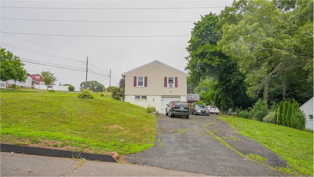 83 View Ter, East Haven, CT 06512 - view of front facade featuring asphalt driveway, an attached garage, and a front yard