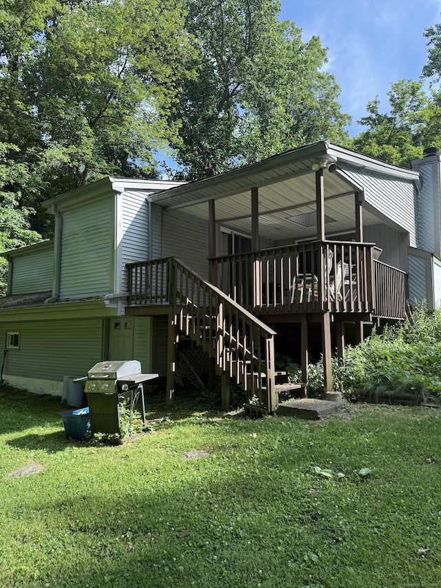 23 Merriman Ln, Prospect, CT 06712 - back of property with a yard, stairs, and a wooden deck