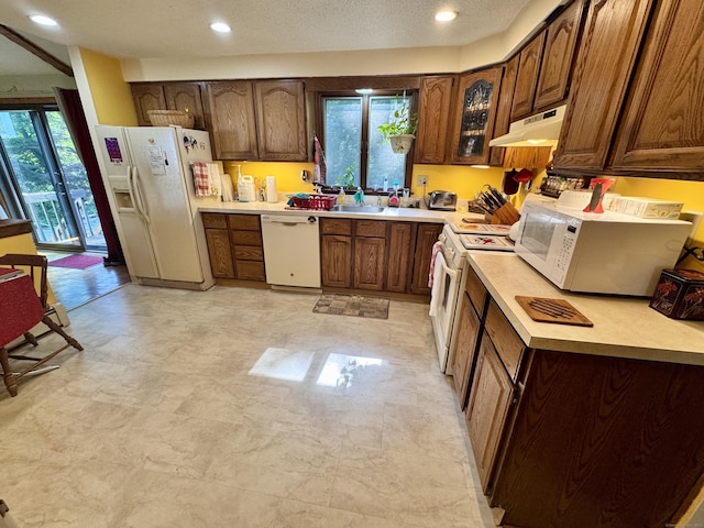 8 Juniper Rd, Windsor, CT 06095 - kitchen featuring white appliances, under cabinet range hood, light countertops, recessed lighting, and glass insert cabinets