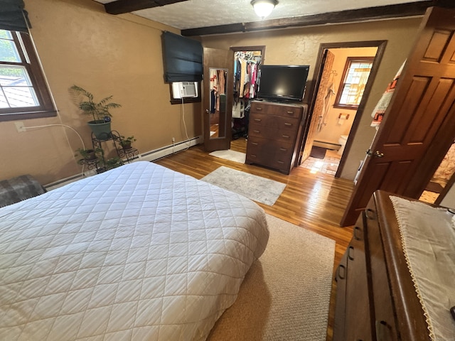 8 Juniper Rd, Windsor, CT 06095 - bedroom featuring wood finished floors, a baseboard heating unit, and a walk in closet