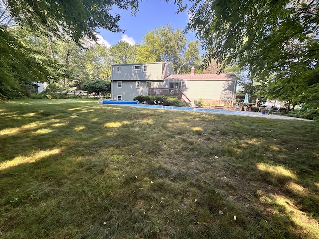 8 Juniper Rd, Windsor, CT 06095 - rear view of house with a deck, a chimney, a pool, and a lawn