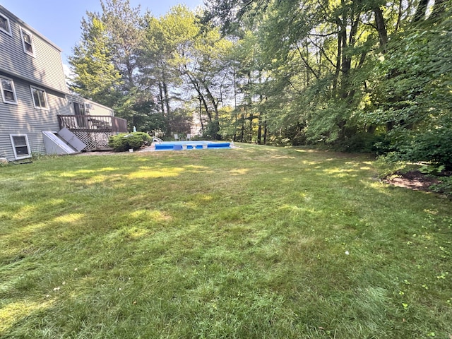 8 Juniper Rd, Windsor, CT 06095 - view of grassy yard with a deck and an outdoor pool