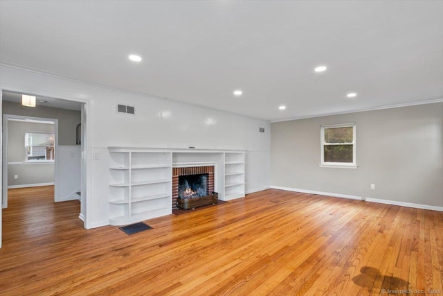 210 Highland Ave, West Haven, CT 06516 - unfurnished living room with light wood-style flooring, recessed lighting, ornamental molding, a fireplace, and built in shelves