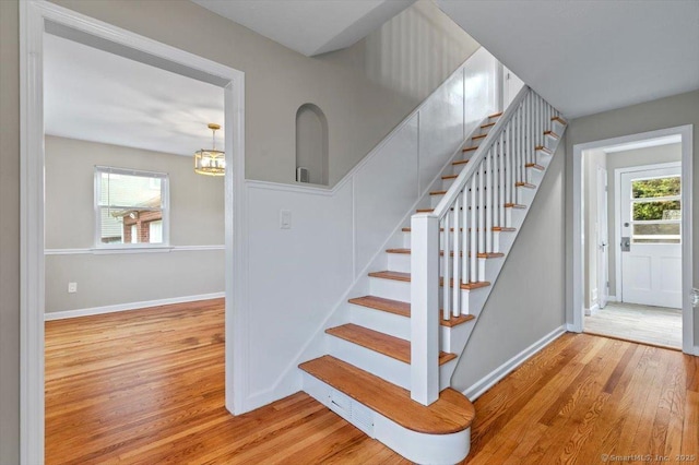 210 Highland Ave, West Haven, CT 06516 - stairs featuring wood finished floors and a chandelier